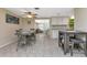 Bright dining room with tile floors, a table for four, and an open concept layout at 2051 Mississippi Ave, Englewood, FL 34224