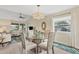Dining area with glass table, four chairs, and view to living room at 6796 Gasparilla Pines Blvd # 48, Englewood, FL 34224