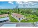 Condo building with carport and surrounding green space at 6796 Gasparilla Pines Blvd # 48, Englewood, FL 34224