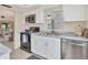 Modern kitchen with stainless steel appliances and white cabinets at 6796 Gasparilla Pines Blvd # 48, Englewood, FL 34224