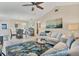Bright living room features vaulted ceilings, comfy seating, and large artwork at 6796 Gasparilla Pines Blvd # 48, Englewood, FL 34224