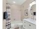 Bathroom with tub and shower, and white vanity at 6796 Gasparilla Pines Blvd # 48, Englewood, FL 34224