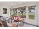 Relaxing sunroom with ample seating and screened windows at 6796 Gasparilla Pines Blvd # 48, Englewood, FL 34224