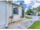 Exterior view of building entrance with landscaping and walkway at 6796 Gasparilla Pines Blvd # 48, Englewood, FL 34224