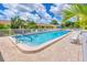 Community pool with ample deck space and lounge chairs at 6796 Gasparilla Pines Blvd # 48, Englewood, FL 34224
