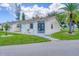 Exterior view of a light-colored building with a brown roof and lush lawn at 6796 Gasparilla Pines Blvd # 48, Englewood, FL 34224