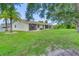 Condo with a spacious backyard, lush lawn, and mature shade trees at 6796 Gasparilla Pines Blvd # 48, Englewood, FL 34224