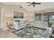 Living room with light-colored couches, glass coffee table, and area rug at 6796 Gasparilla Pines Blvd # 48, Englewood, FL 34224