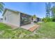 Private backyard with patio and lush landscaping at 6796 Gasparilla Pines Blvd # 48, Englewood, FL 34224
