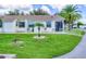 Exterior view of a light-colored building with a palm tree and lawn at 6796 Gasparilla Pines Blvd # 48, Englewood, FL 34224