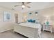 Bright main bedroom with king-size bed and ensuite bathroom at 6796 Gasparilla Pines Blvd # 48, Englewood, FL 34224