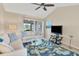 Living room with sectional sofa, glass coffee table, and TV at 6796 Gasparilla Pines Blvd # 48, Englewood, FL 34224