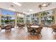 Community room with multiple seating areas and large windows at 8409 Placida Rd # 308, Placida, FL 33946