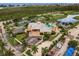 Aerial view of community with pool, tennis courts, and parking at 8409 Placida Rd # 308, Placida, FL 33946
