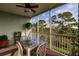 Private screened balcony with outdoor seating and nature views at 8409 Placida Rd # 308, Placida, FL 33946