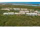 Aerial view showcasing community building location and neighborhood at 8409 Placida Rd # 308, Placida, FL 33946