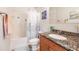 Clean bathroom with granite countertop and shower/tub combo at 8409 Placida Rd # 308, Placida, FL 33946