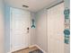 Bright entryway with white door, tile flooring, and coat closet at 8409 Placida Rd # 308, Placida, FL 33946