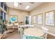 Relaxing community room with tables, chairs, and floor plans on display at 8409 Placida Rd # 308, Placida, FL 33946