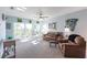 Spacious living area featuring a brown leather sofa and access to a private balcony at 8409 Placida Rd # 308, Placida, FL 33946