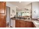 Kitchen with granite countertops, wooden cabinets, and stainless steel sink at 8409 Placida Rd # 308, Placida, FL 33946