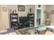Bright living room featuring built-in shelving and a view into another room at 13524 Abercrombie Dr, Englewood, FL 34223