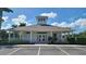 Community clubhouse with ample parking and inviting entrance at 13524 Abercrombie Dr, Englewood, FL 34223