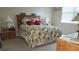 Cozy bedroom with leafy bedding and wood furniture at 13524 Abercrombie Dr, Englewood, FL 34223