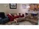 Living room with red sofa, coffee table, and adjacent dining area at 13524 Abercrombie Dr, Englewood, FL 34223