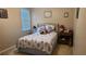 Guest bedroom with seashell bedding and a bedside table at 13524 Abercrombie Dr, Englewood, FL 34223