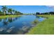 Serene canal view with lush greenery and palm trees at 13524 Abercrombie Dr, Englewood, FL 34223