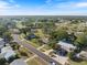 Overhead shot showcases a tranquil neighborhood with mature trees, winding roads, and neatly arranged homes under a bright sky at 6517 Kenwood Dr, North Port, FL 34287
