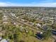 High-angle view of a peaceful community featuring tree-lined streets, manicured lawns, and cozy homes nestled in a serene setting at 6517 Kenwood Dr, North Port, FL 34287