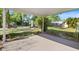 Spacious backyard with a covered patio and lush greenery at 6517 Kenwood Dr, North Port, FL 34287