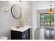 Updated bathroom featuring a modern vanity and view into the dining room at 6517 Kenwood Dr, North Port, FL 34287