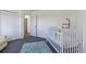 Spacious Bedroom featuring a crib, closet, and open doorway at 6517 Kenwood Dr, North Port, FL 34287