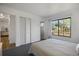 Bedroom featuring a large window, carpet, plus closet, hallway, and bathroom access at 6517 Kenwood Dr, North Port, FL 34287