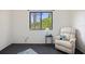 Bright bedroom featuring a large window, comfortable chair, and plenty of natural light at 6517 Kenwood Dr, North Port, FL 34287