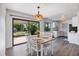 Dining area with wood table and chairs next to a sliding glass door and kitchen at 6517 Kenwood Dr, North Port, FL 34287