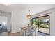 Dining area with table set, next to sliding door with backyard view, plus bedroom view at 6517 Kenwood Dr, North Port, FL 34287