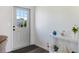 Bright entryway featuring a stylish door, decor, and wood-look flooring at 6517 Kenwood Dr, North Port, FL 34287