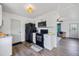 Bright kitchen with black appliances, white cabinets, and wood-look flooring at 6517 Kenwood Dr, North Port, FL 34287