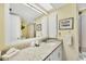 Bathroom with granite countertop, white cabinets, and a shower/tub combo at 7070 Placida Rd # 1221, Placida, FL 33946