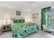 King-size bed with tropical bedding, nightstands, and ceiling fan at 7070 Placida Rd # 1221, Placida, FL 33946