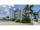 Exterior view of a condo building with palm trees and walkway at 7070 Placida Rd # 1221, Placida, FL 33946
