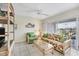 Living room with wicker furniture, TV, and access to balcony at 7070 Placida Rd # 1221, Placida, FL 33946