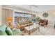 Living room with floral sofa, wicker furniture, and water views at 7070 Placida Rd # 1221, Placida, FL 33946
