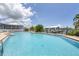 Refreshing community pool with water view and lounge chairs at 7070 Placida Rd # 1221, Placida, FL 33946