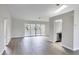 Bright living room with wood-look floors and sliding doors at 189 Bunker Rd, Rotonda West, FL 33947