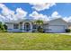 Single story home with white exterior and palm trees at 189 Bunker Rd, Rotonda West, FL 33947